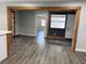 Open-concept living room with wood-look floors and natural wood trim at 1920 N Highland Ave, Clearwater, FL 33755