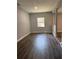 Room with wood-look floors, window, and neutral paint at 1920 N Highland Ave, Clearwater, FL 33755