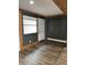 Room with wood-look floors and dark-painted accent wall at 1920 N Highland Ave, Clearwater, FL 33755