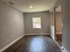 Room with wood-look floors, window, and neutral paint at 1920 N Highland Ave, Clearwater, FL 33755