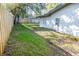 Large backyard with a wooden fence and mature trees at 1920 N Highland Ave, Clearwater, FL 33755