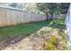 Backyard with wooden fence and grass at 1920 N Highland Ave, Clearwater, FL 33755