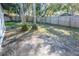 Backyard with mature trees and wooden fence at 1920 N Highland Ave, Clearwater, FL 33755