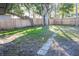 Fenced backyard with mature trees and a grassy area at 1920 N Highland Ave, Clearwater, FL 33755