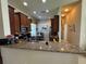 Kitchen with granite countertops, stainless steel appliances, and a breakfast nook with a view to the outside at 15953 Cobble Mill Dr, Wimauma, FL 33598
