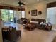 Inviting living room featuring tile floors, comfortable seating, and sliding glass doors to a screened-in patio at 15953 Cobble Mill Dr, Wimauma, FL 33598