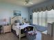 Light and airy main bedroom features a neutral color palette, ceiling fan, and plenty of natural light at 15953 Cobble Mill Dr, Wimauma, FL 33598