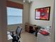 Office space with a desk, chair, and natural light from the window, perfect for a home workspace at 15953 Cobble Mill Dr, Wimauma, FL 33598