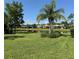 Beautiful pond view showing landscaping and adjacent properties from a well-maintained lawn at 15953 Cobble Mill Dr, Wimauma, FL 33598
