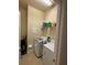 Convenient laundry room with washer, dryer, and shelving at 15953 Cobble Mill Dr, Wimauma, FL 33598