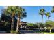 Attractive community entrance with palm trees and landscaping at 15953 Cobble Mill Dr, Wimauma, FL 33598