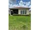 Screened patio with grassy backyard and manicured hedges at 15953 Cobble Mill Dr, Wimauma, FL 33598