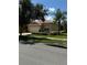 Tan house with a red tile roof and two car garage at 15953 Cobble Mill Dr, Wimauma, FL 33598
