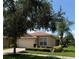 Tan house with a red tile roof and two car garage at 15953 Cobble Mill Dr, Wimauma, FL 33598