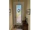 Entryway with decorative glass door and small table at 15953 Cobble Mill Dr, Wimauma, FL 33598