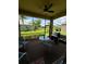 Relaxing screened patio with outdoor grill and seating at 15953 Cobble Mill Dr, Wimauma, FL 33598