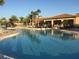 Stunning resort-style pool with palm trees and lounge chairs at 15953 Cobble Mill Dr, Wimauma, FL 33598