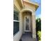 Front entry with arched doorway and decorative glass at 15953 Cobble Mill Dr, Wimauma, FL 33598