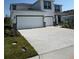 Inviting two-story home with a three-car garage and a well-manicured lawn at 18320 Fattoria Ter, Lakewood Ranch, FL 34211