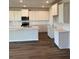 Modern kitchen features white cabinets, marble countertops, and stainless steel appliances at 18320 Fattoria Ter, Lakewood Ranch, FL 34211