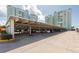 Covered parking area with spaces for residents at 400 64Th Ave # 704, St Pete Beach, FL 33706