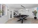 Bright game room features modern pool table with black felt, designer lighting, and coastal decor at 780 Eldorado Ave, Clearwater, FL 33767