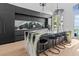 Features an island with countertop seating and stone accents, enhanced by stylish pendant lighting and sleek cabinetry at 780 Eldorado Ave, Clearwater, FL 33767