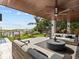 Covered patio features modern outdoor furniture, a pool, beach access and spiral staircase at 780 Eldorado Ave, Clearwater, FL 33767