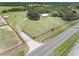 Aerial view of the property featuring a ranch home, horse barn, and expansive acreage at 8602 State Road 674, Wimauma, FL 33598