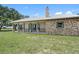 Inviting ranch-style home featuring a stone facade, metal roof, and charming porch at 8602 State Road 674, Wimauma, FL 33598