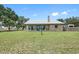 Attractive ranch-style home with a stone chimney, and a metal roof on a spacious lot at 8602 State Road 674, Wimauma, FL 33598