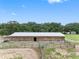 Long barn with many stalls and a metal roof at 8602 State Road 674, Wimauma, FL 33598