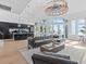 Bright living room boasts a large sectional sofa, a statement chandelier, and ocean views at 780 Eldorado Ave, Clearwater, FL 33767