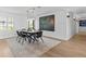 Bright dining room with modern table and chairs, hardwood floors, and large artwork at 780 Eldorado Ave, Clearwater, FL 33767