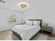 Well-lit bedroom with a queen bed, light wood floors, and a window at 780 Eldorado Ave, Clearwater, FL 33767