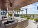 Covered patio with comfortable seating, overlooking the pool and beach at 780 Eldorado Ave, Clearwater, FL 33767