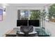 Home office with dual monitors and glass desk, overlooking a private garden at 780 Eldorado Ave, Clearwater, FL 33767