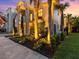 Well-lit home exterior with lush landscaping and palm trees at 780 Eldorado Ave, Clearwater, FL 33767