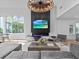 Spacious living area featuring a large TV and modern fireplace at 780 Eldorado Ave, Clearwater, FL 33767