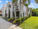 Landscaped two story home with lush greenery at 780 Eldorado Ave, Clearwater, FL 33767