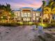 Luxury beachfront home with tropical landscaping, at dusk at 780 Eldorado Ave, Clearwater, FL 33767