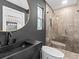 Contemporary bathroom with walk-in shower and dark accents at 780 Eldorado Ave, Clearwater, FL 33767