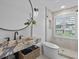 Modern bathroom with marble vanity, large mirror, and walk-in shower at 780 Eldorado Ave, Clearwater, FL 33767