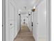 Light and airy hallway with hardwood floors and modern light fixtures at 780 Eldorado Ave, Clearwater, FL 33767