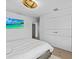 Bright bedroom with queen bed, wood floors, and large TV at 780 Eldorado Ave, Clearwater, FL 33767
