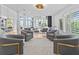 Open concept sitting area with gray armchairs, view to living room at 780 Eldorado Ave, Clearwater, FL 33767