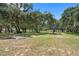 Spacious pasture with mature oak trees and a covered area at 8602 State Road 674, Wimauma, FL 33598