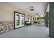 Long covered porch with stone accents and French doors at 8602 State Road 674, Wimauma, FL 33598