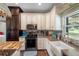 Modern kitchen with stainless steel appliances and farmhouse sink at 8602 State Road 674, Wimauma, FL 33598