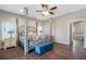 Main bedroom with a four poster bed and ensuite bathroom at 8602 State Road 674, Wimauma, FL 33598